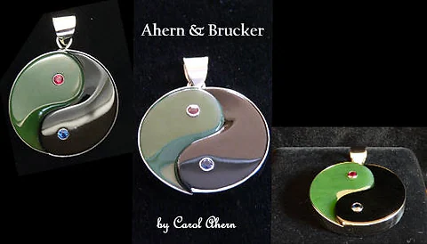 A Green and Black Jade Yin Yang Pendant